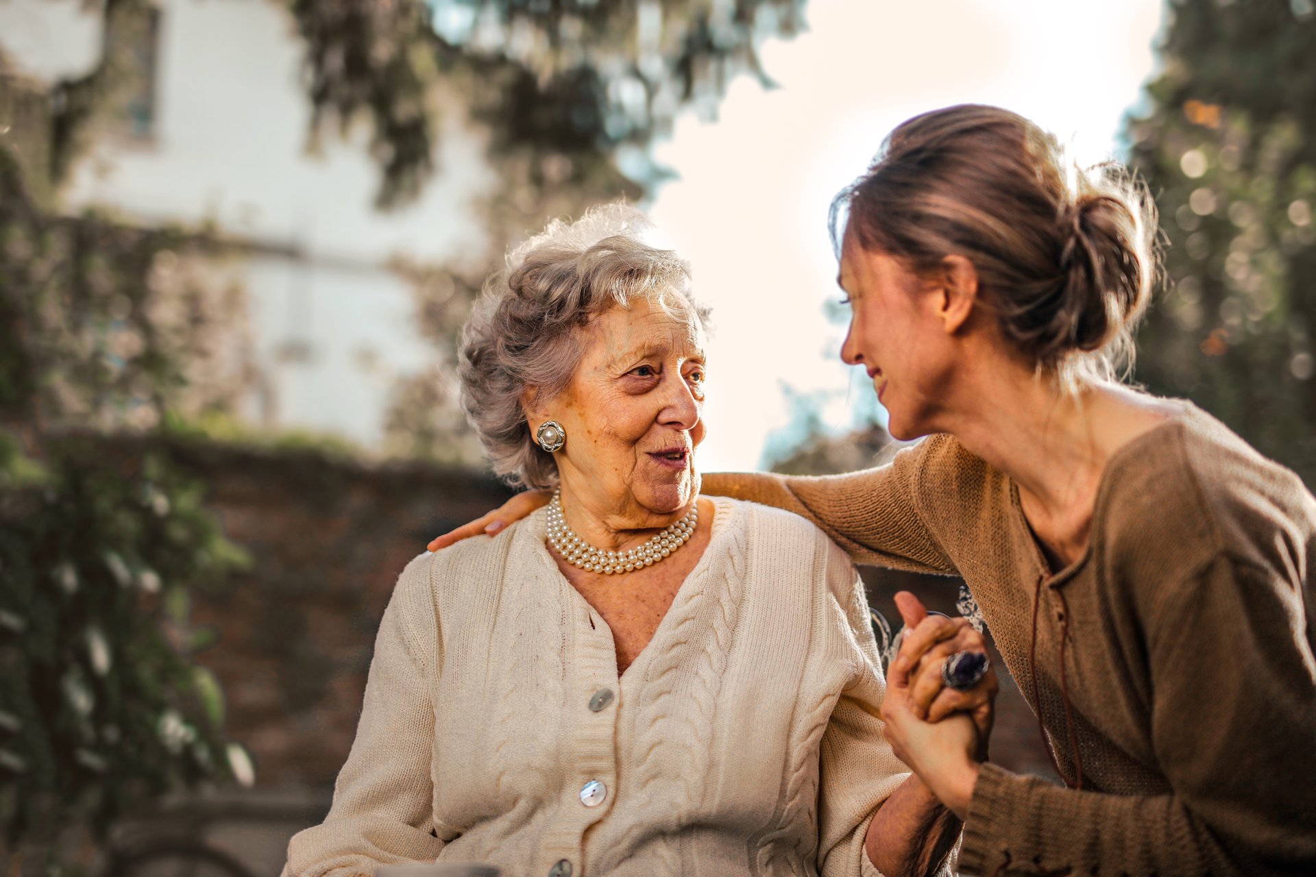 A happy daughter greeting happy surprised senior